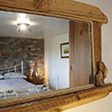mirror with view of double bed at Beudy carrog