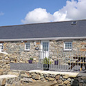 View of Beudy Carrog outside with steps and picnic table