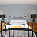 double bed with large bedisde tables on each side at Stables Carrog