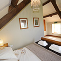 double bed in gabled room at Stables Carrog