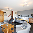 two armchairs with bed in background at Stables Carrog